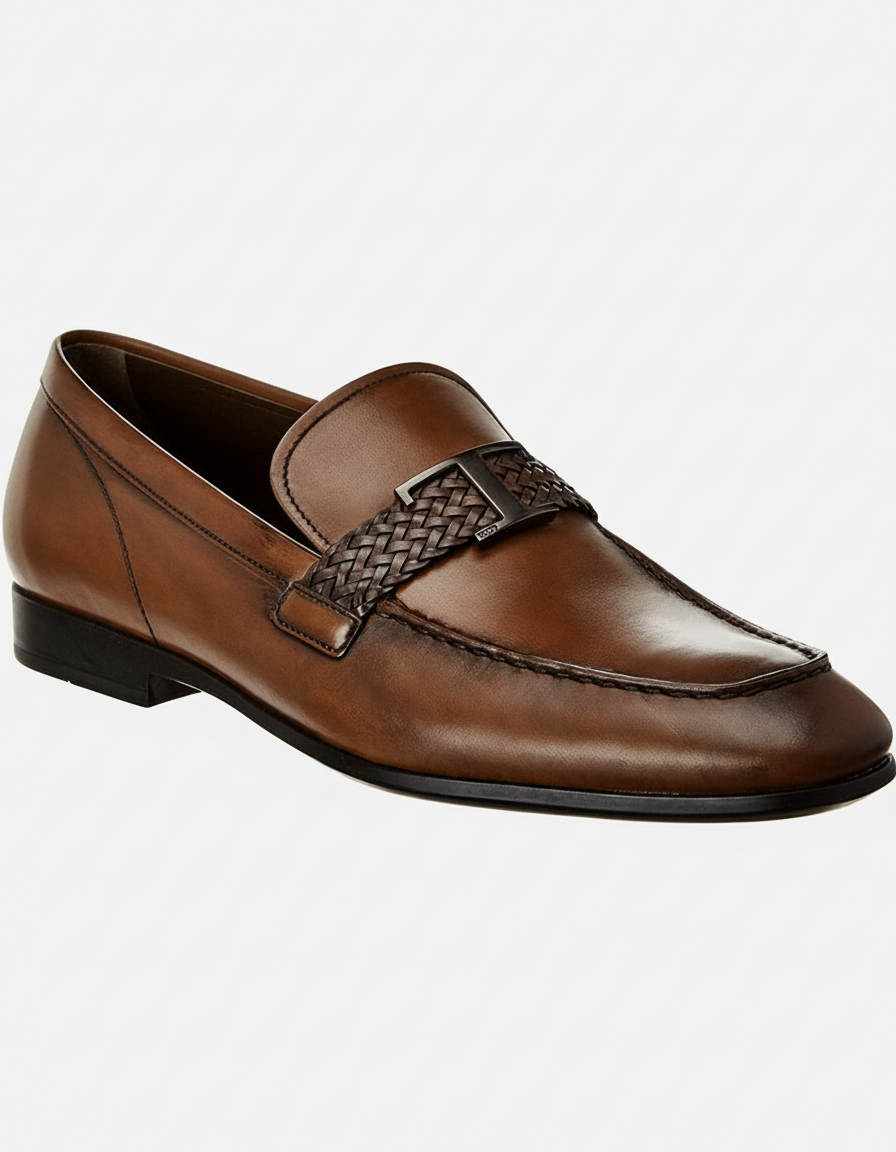 Brown leather loafer with a braided strap and metal "T" logo.