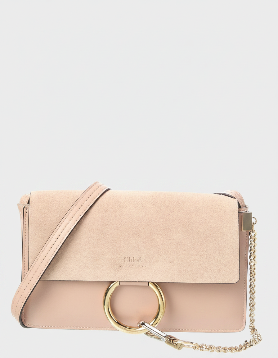 A light pink Chloe crossbody bag with a gold ring detail.