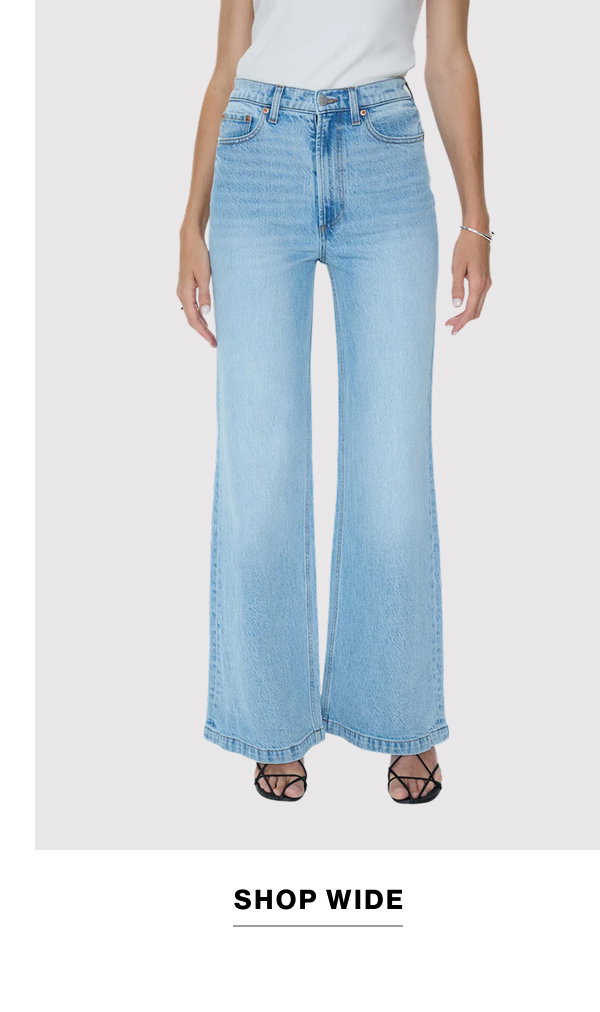 an image of a woman in jeans and a green shirt