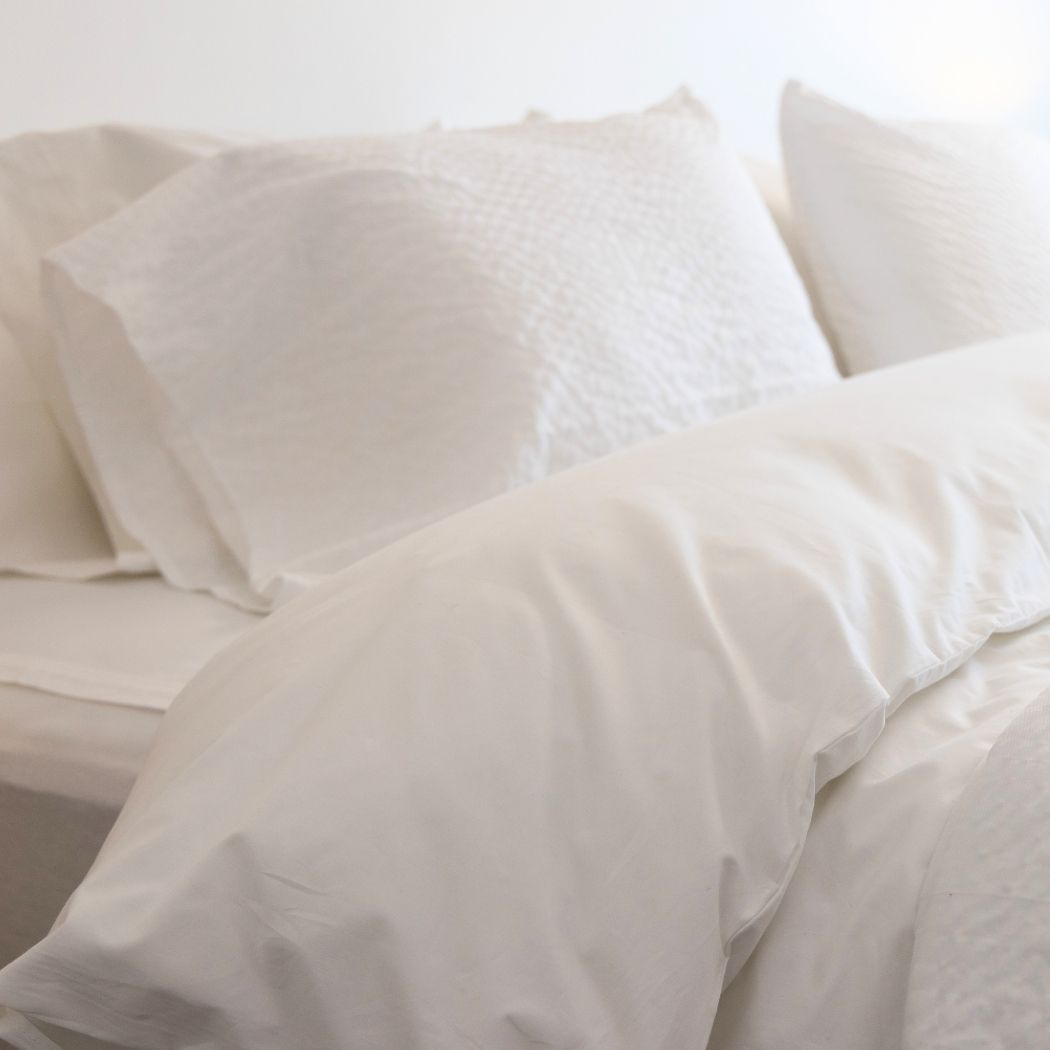 A bed made up in white sheets
