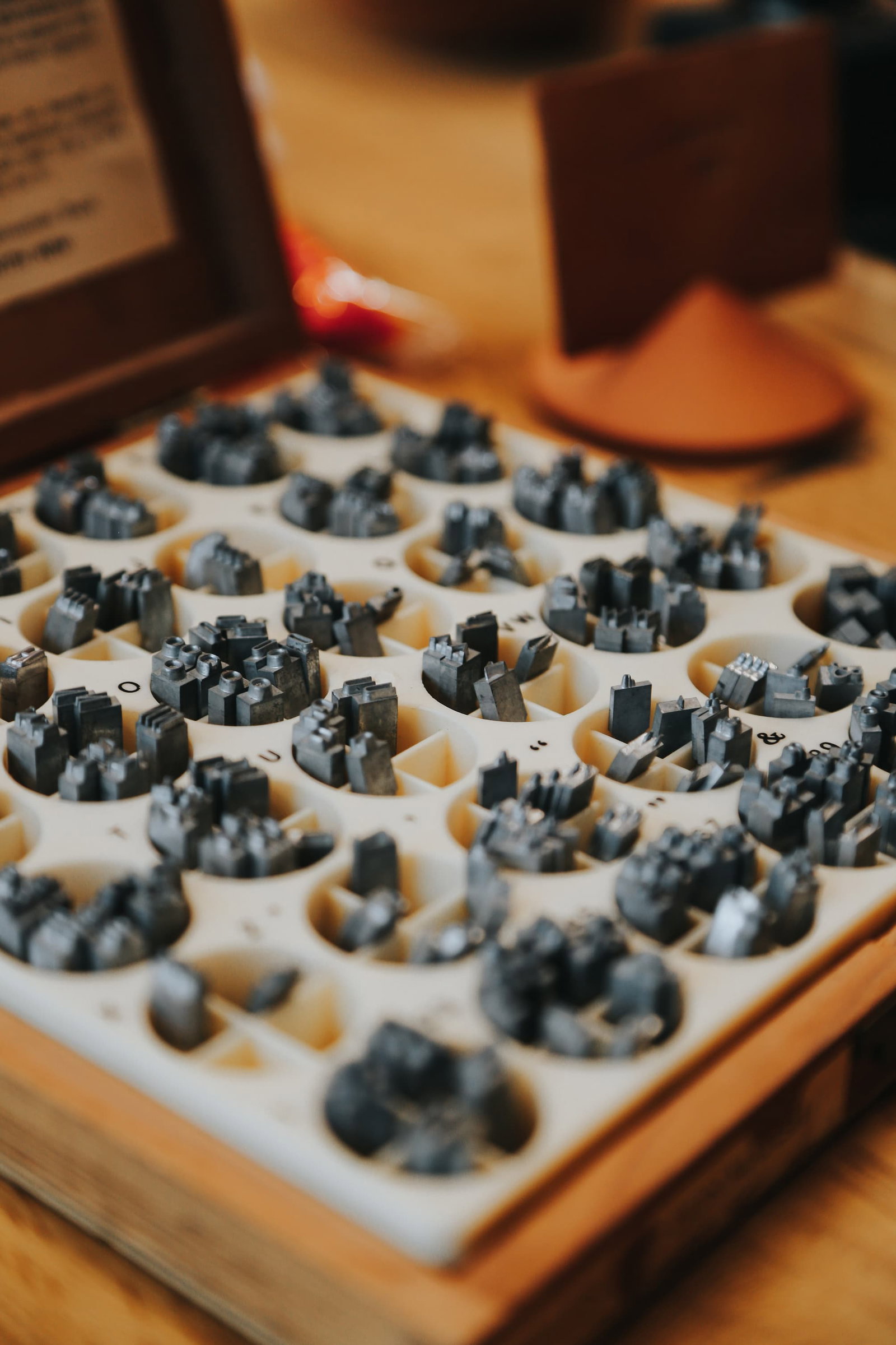 Lead stamps in a wooden box used for custom monograming of leather goods