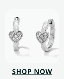Silver huggies featuring a pavé-set heart charm hanging from the front. Click here to shop now