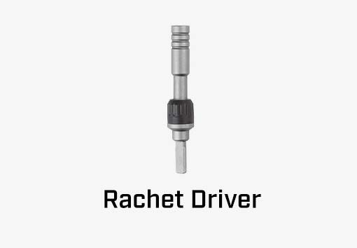 A leatherman rachet driver attachment on a gray background