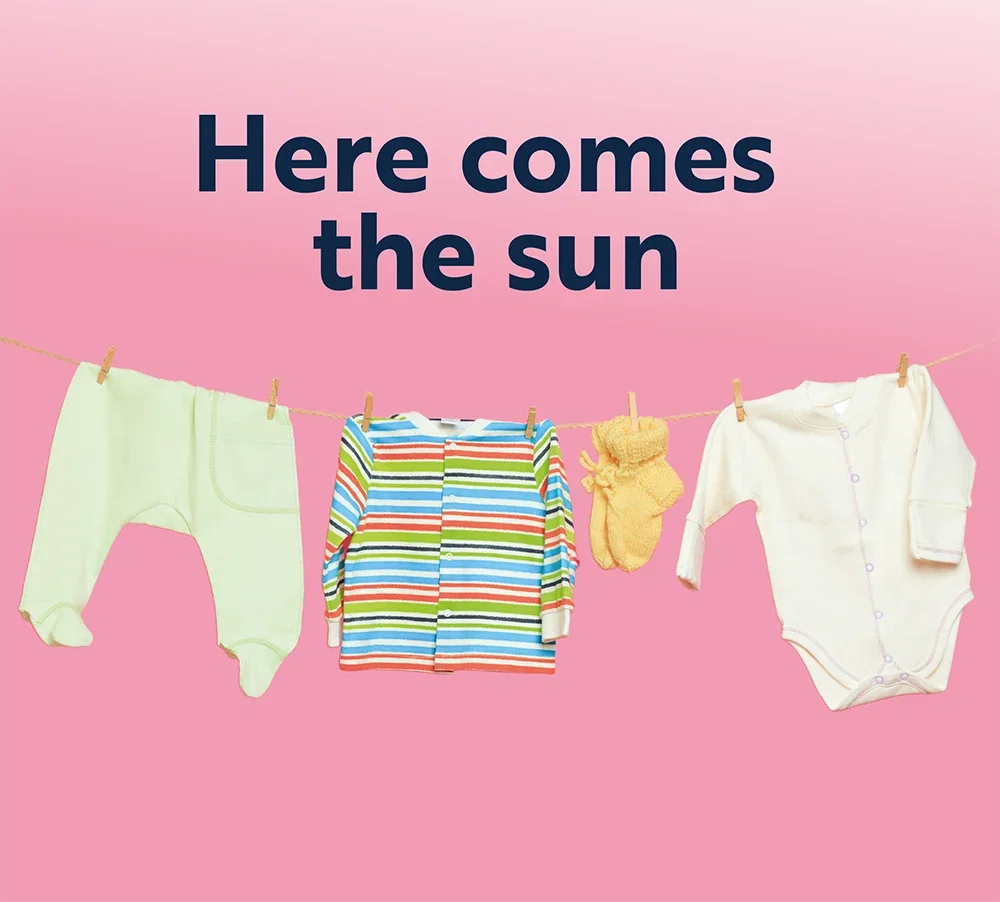"Here comes the sun" washing line with clothes hung on it