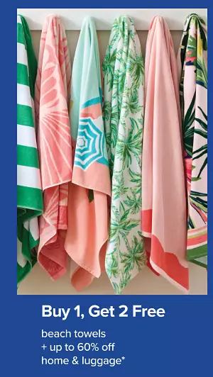 Buy one get 2 free beach towels. Plus up to 60% off home and luggage. A rack of hanging beach towels.