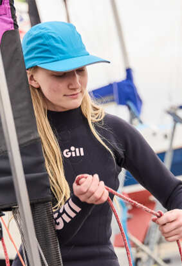 A Junior pulling a rope wearing a Blue Hat