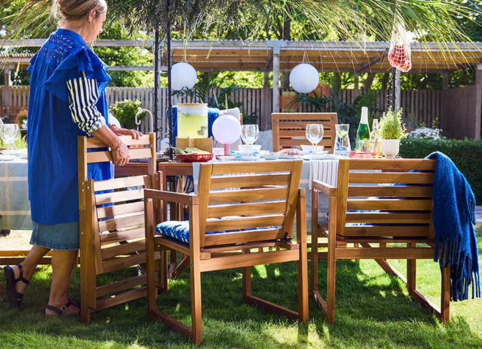 Woman setting up outdoor IKEA furniture