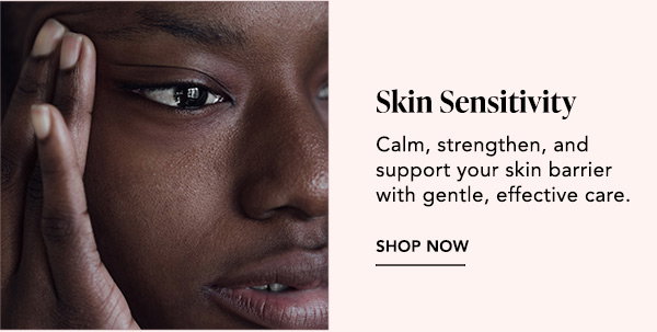 Portrait: Close-up of a woman touching her face with sensitive skin