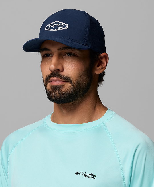 A man wearing a navy ball cap with a PFG logo on the front.