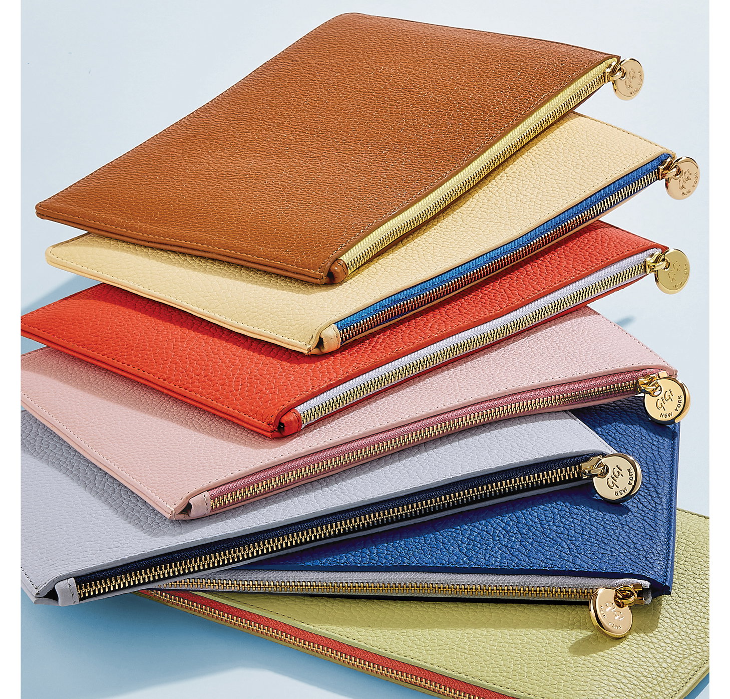 The Birdie Pouch in Tan, Chiffon, Coral, Pink, Periwinkle, Cobalt, and Celadon.