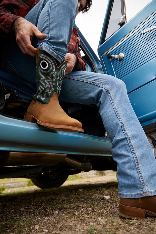 A man wearing the Big News 11" Western in Pecan (Brown).
