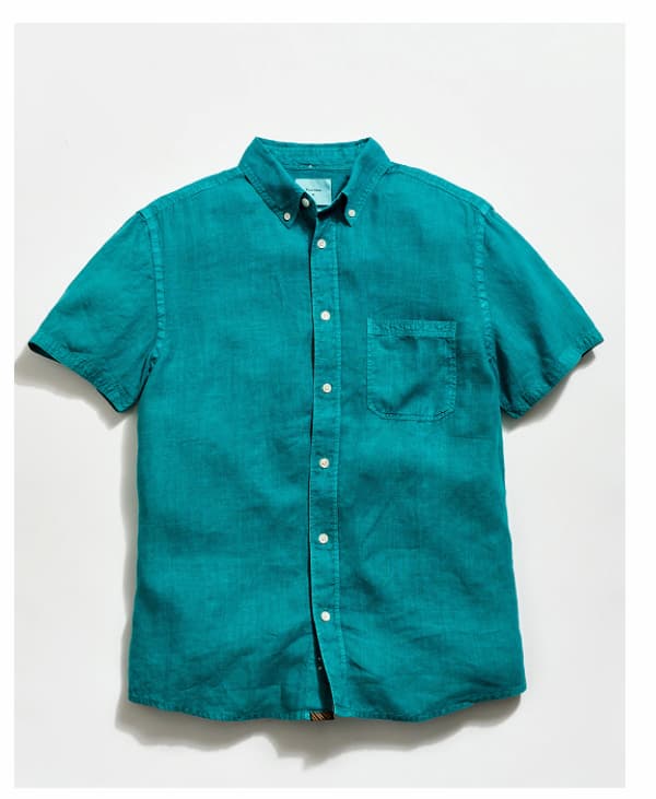 A teal shirt on a grey background
