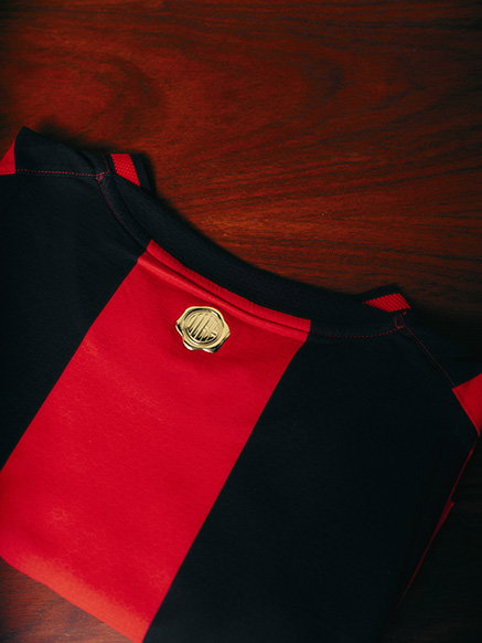AC Milan Home 26/27 Jersey folded up on a table, image taken of the back of the shirt.