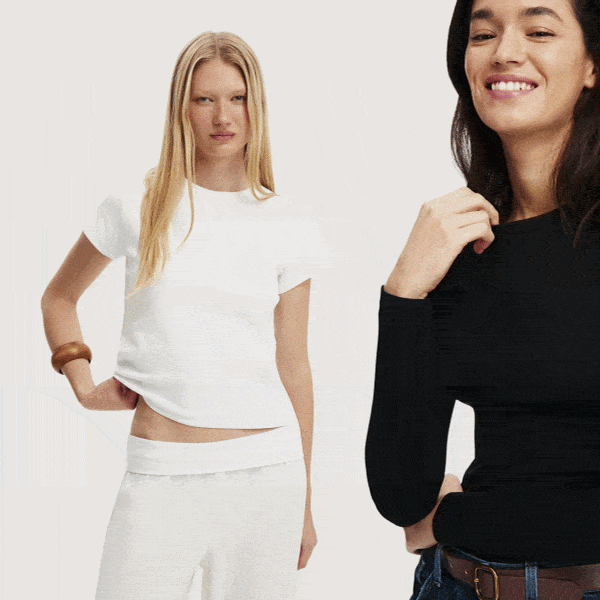 Two women modeling white and black long sleeve tops