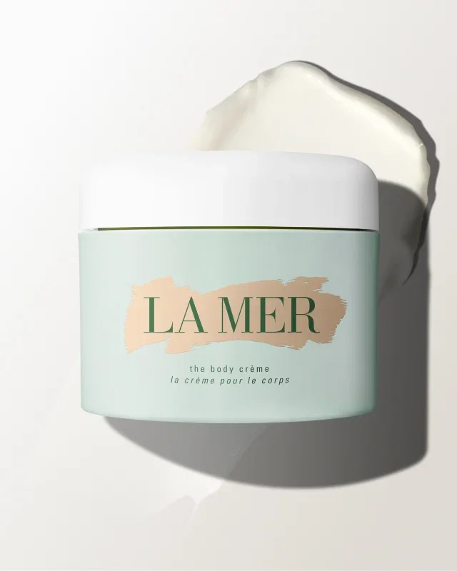 Jar of The Body Crème with cream smear in the background.