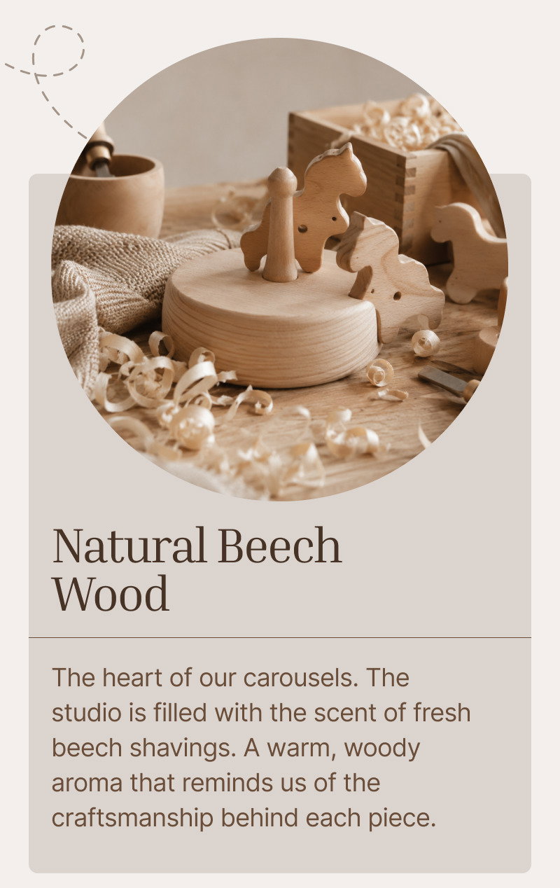 Wooden carousel pieces, small animal figures, beads, and natural materials arranged on a soft studio table.