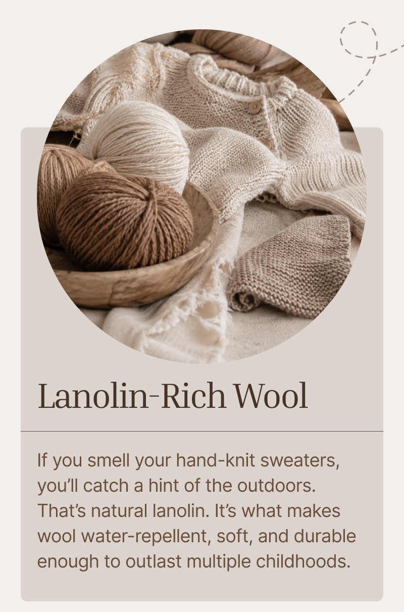 Balls of brown and cream wool resting beside knitted textures and soft fabric in a neutral studio setting.