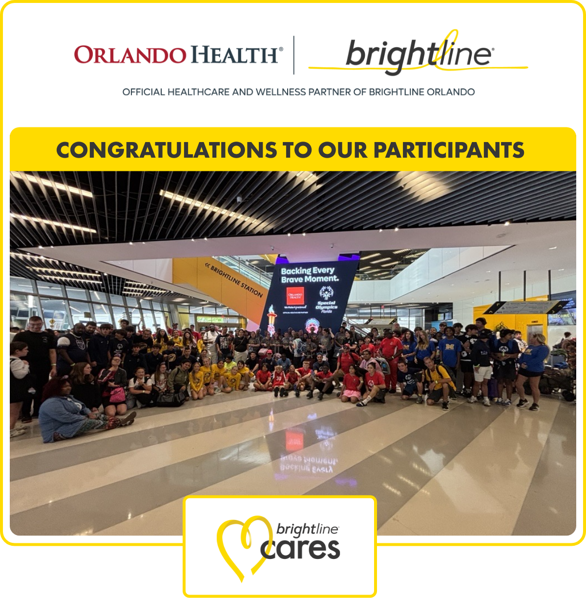 A large group of participants pose together inside a modern Brightline Orlando station concourse. The image features a wide digital display in the background with colorful graphics and event messaging.