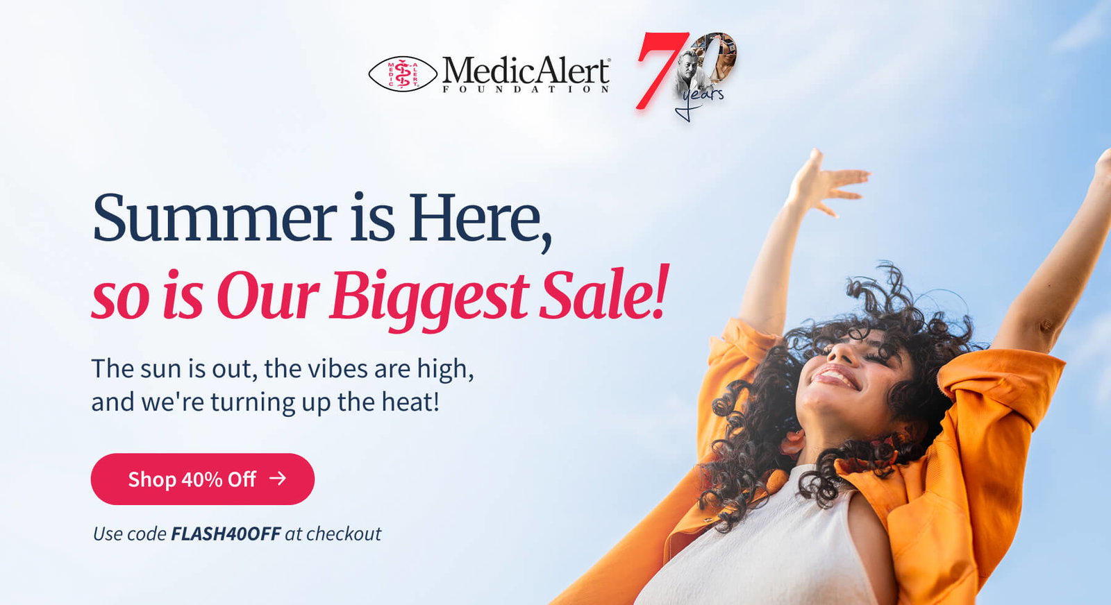 Header image for the MedicAlert Foundation Biggest Sale, celebrating '70 Years'. The main text reads 'Summer is Here, so is Our Biggest Sale!'. Below, it states 'The sun is out, the vibes are high, and we're turning up the heat!'. A prominent red button is labeled 'Shop 40% Off'. At the bottom, the call to action reads 'Use code FLASH40OFF at checkout'. The image shows a young woman with curly brown hair, wearing a white halter neck top and an orange jacket, leaning back with her arms raised joyfully against a sunny sky.