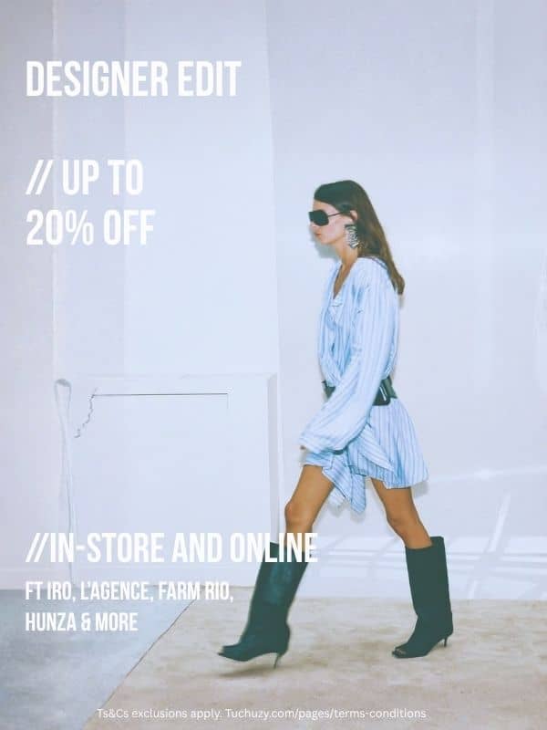 A medium shot shows a woman walking to the right, wearing a light blue striped dress, black boots, and sunglasses, with text 'DESIGNER EDIT // UP TO 2...