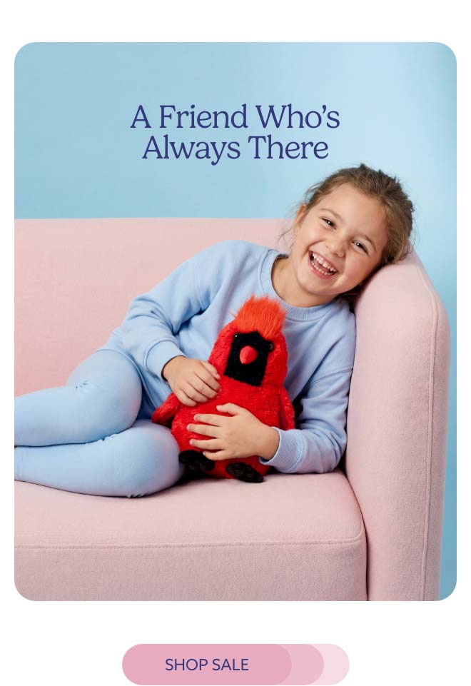 A little girl relaxing on a couch with Cardinal Warmies. Shop Sale.