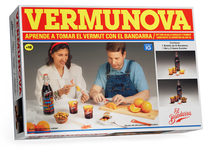 Box cover of VERMUNOVA vermouth kit showing two people preparing vermouth with bottle, glasses, orange slices and snacks