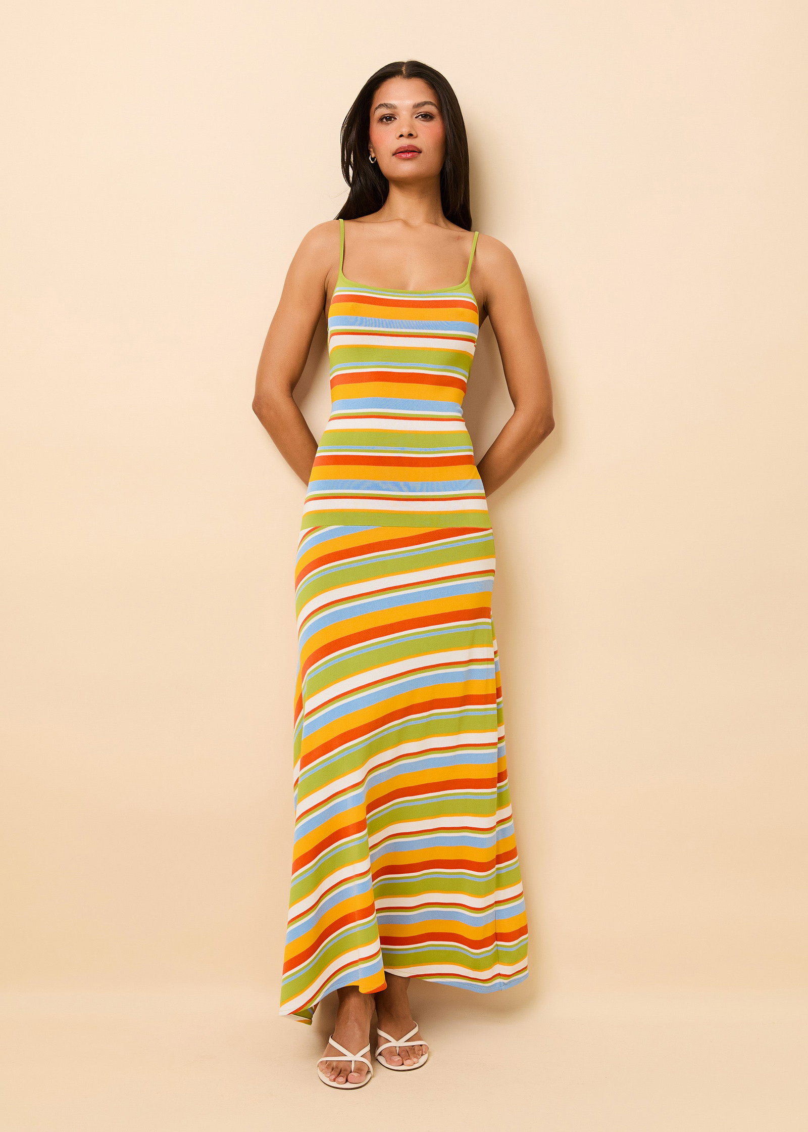 Woman wearing long colorful striped dress