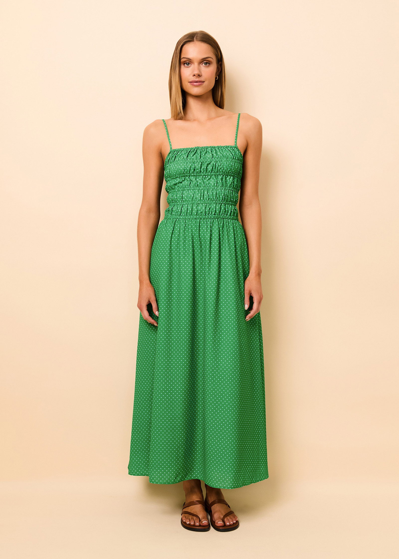 Woman wearing green dress with smocking