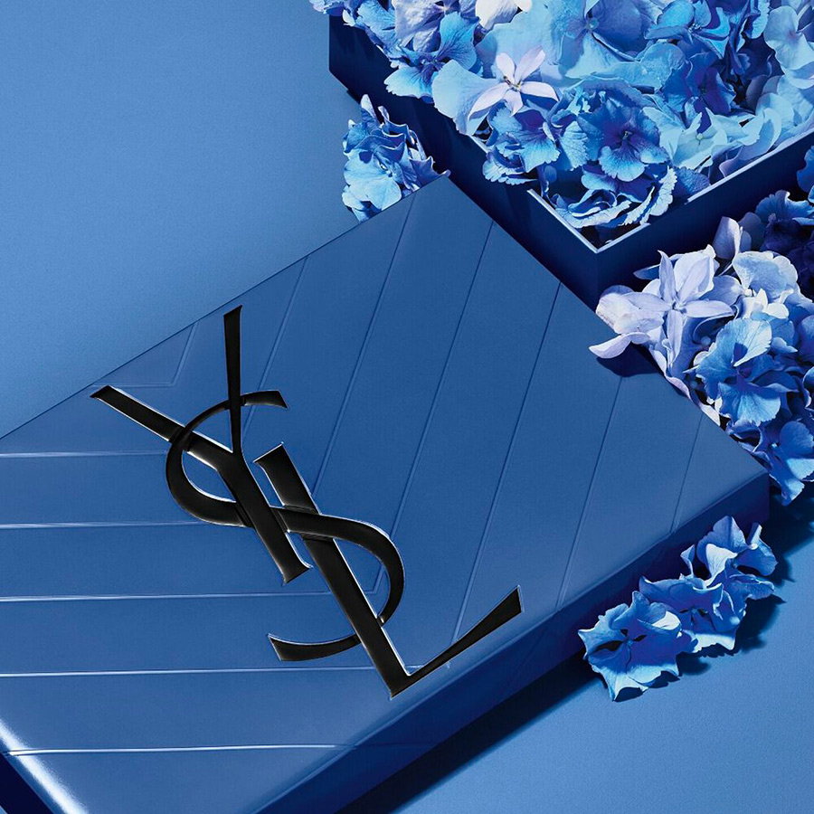 A sophisticated YSL BEAUTY gift box featuring a refined blue floral pattern and the iconic YSL logo, representing the art of luxury gifting