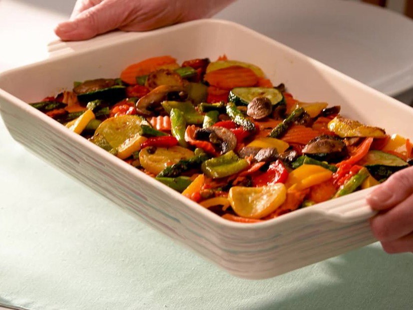 Pyrex roasted vegetable bake served in a ceramic baking dish