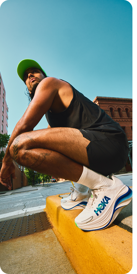 Block of three images showing: a man crouching on a street with a blue sky and buildings in the background; a 3/4 view of a black cap with the text “HOKA” on it; a waist-up image of a man wearing a black vest.
