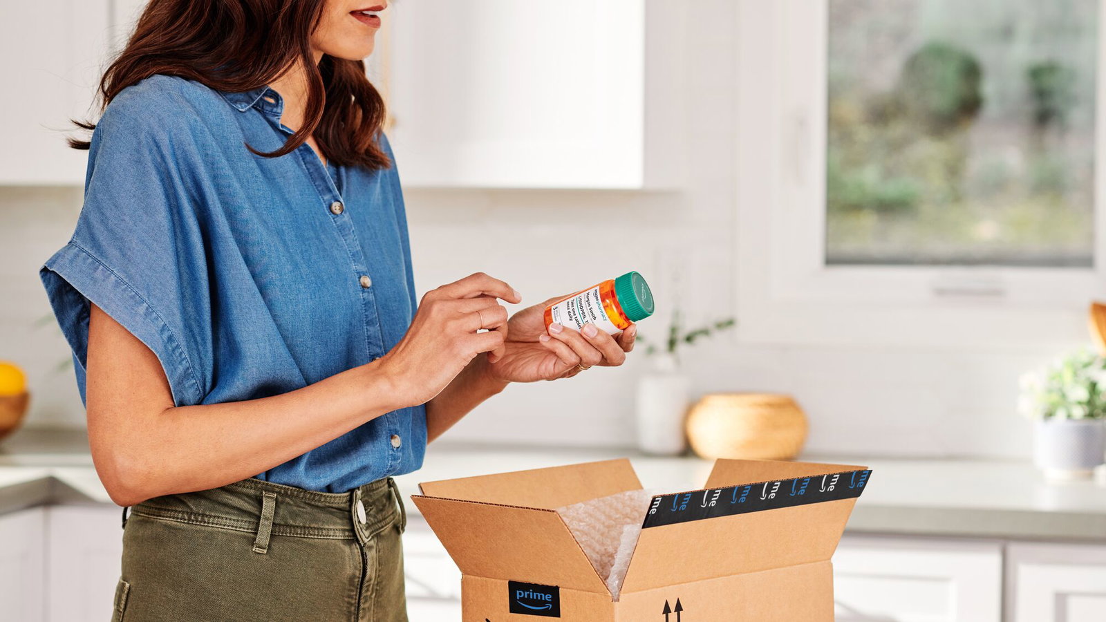 Amazon customer holding an RxPass prescription medication. 
