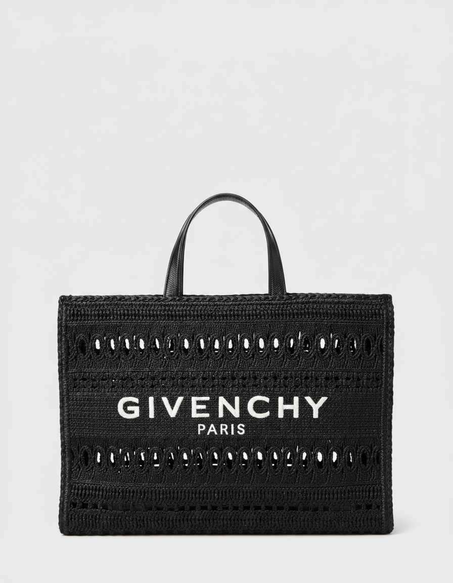 Black Givenchy tote bag with white logo and cut-out details.