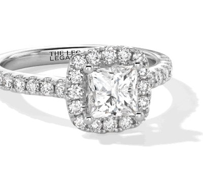 White gold cushion-cut diamond halo ring with pavé band.