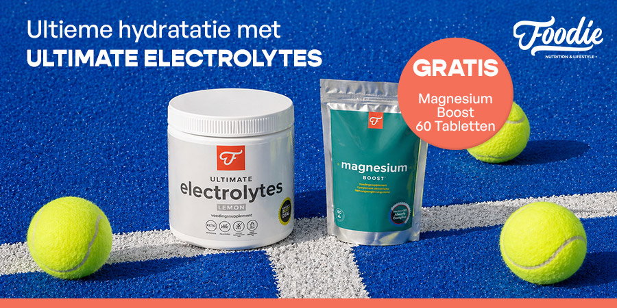 Tub of Ultimate Electrolytes (lemon) and Magnesium Boost pouch with tennis balls on blue court, free 60-tablet bonus