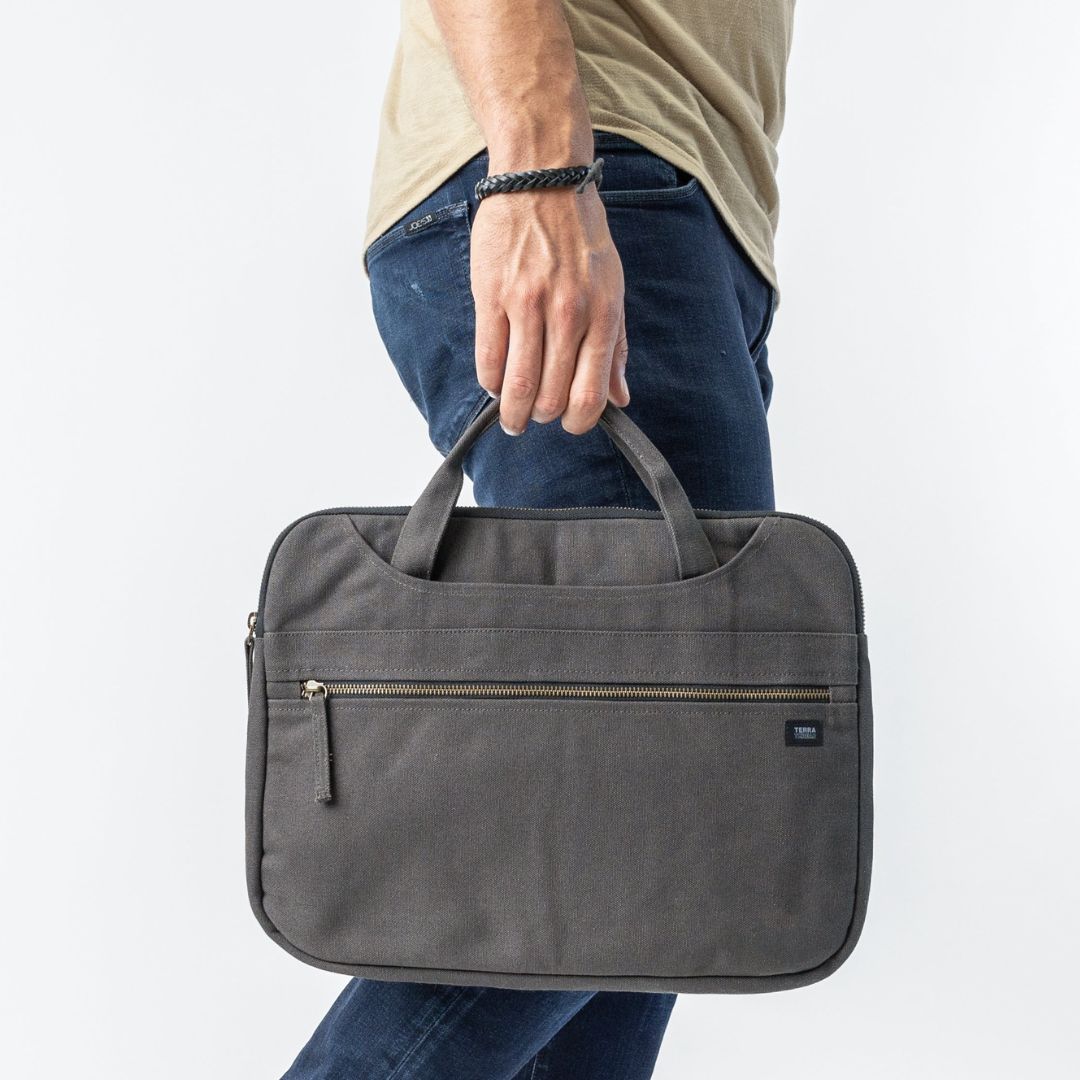 organic cotton duffel bags in black and brown color carried by a man and woman