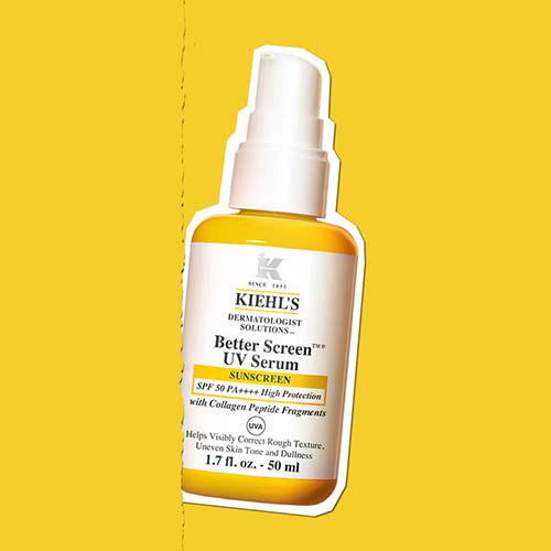 A bottle of Kiehl's Better Screen UV Serum sunscreen against a yellow background. The label indicates it has SPF 50 PA++++ high protection and contains collagen peptide fragments. The bottle is 50 ml or 1.7 fl oz.