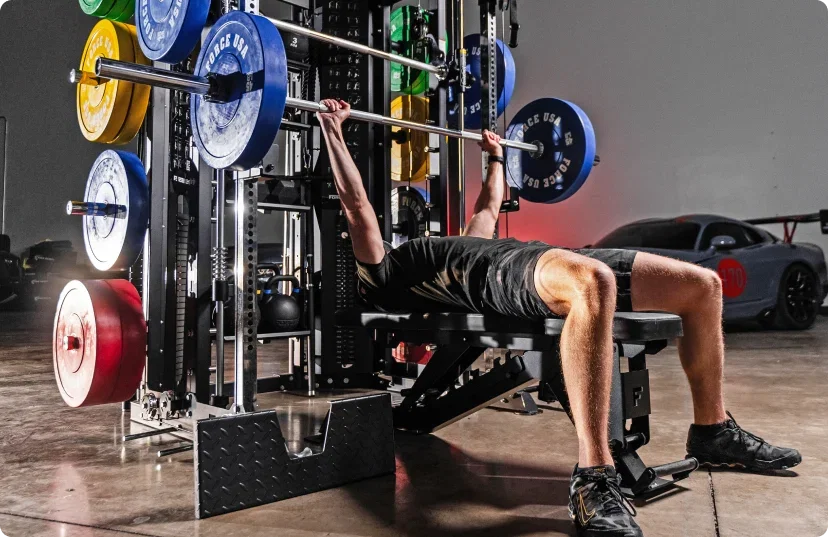 Man doing bench press on Force USA All-In-One Trainer