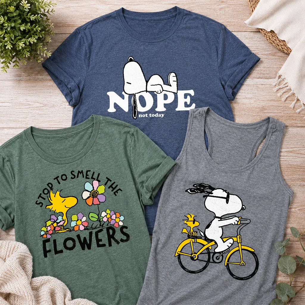 Three Peanuts-themed t-shirts featuring Snoopy designs with text 