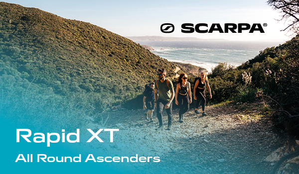 Scarpa Rapid XT: All-Round Ascenders. Four hikers climb a hill, beach visible in the background.