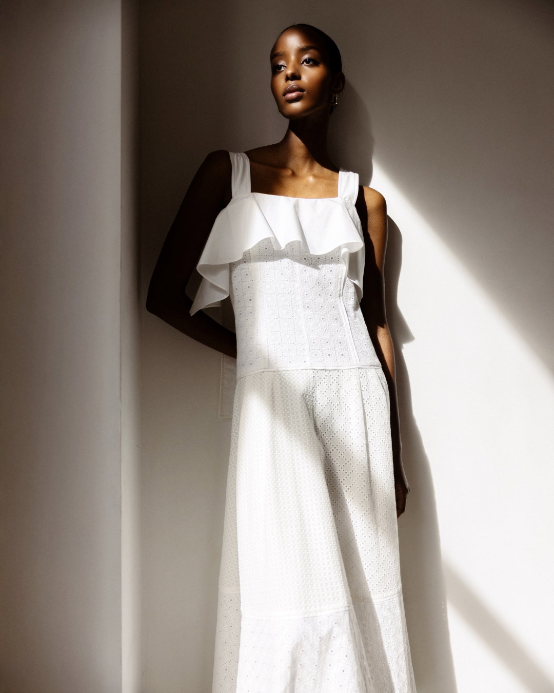 an image of a woman in a white dress holding a purse