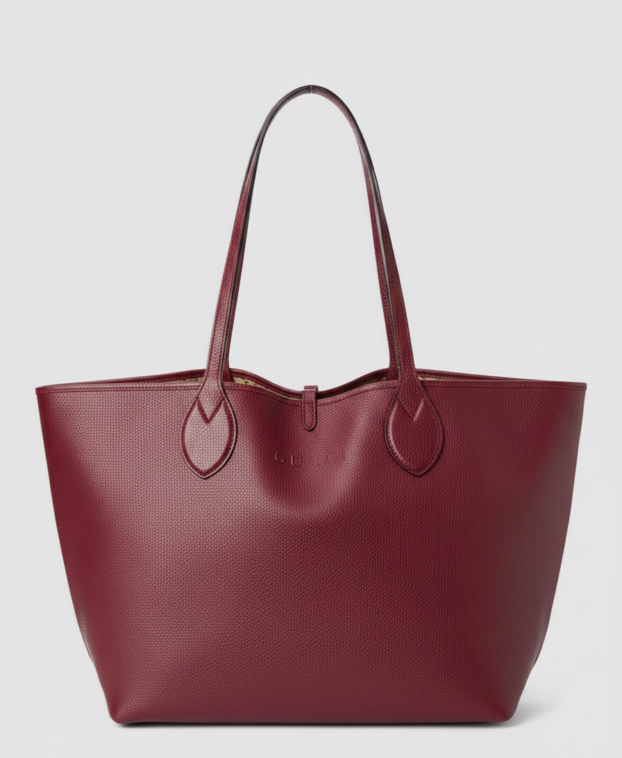 A burgundy leather tote bag with "GUCCI" embossed on the front.