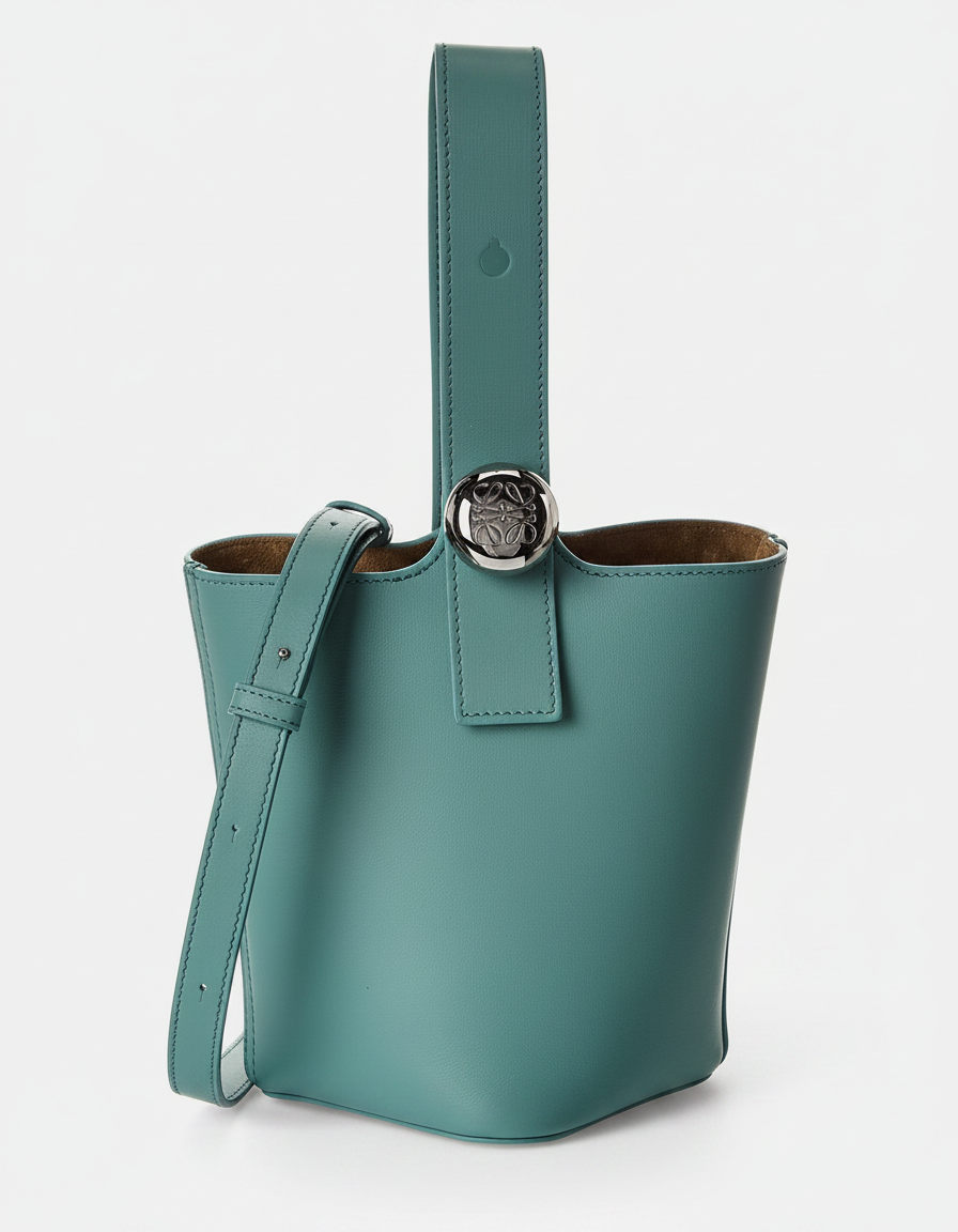 A teal leather bucket bag with a silver logo and a crossbody strap.
