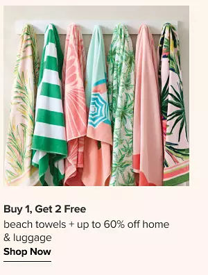 Buy one get 2 free beach towels. Plus up to 60% off home and luggage. A rack of hanging beach towels.