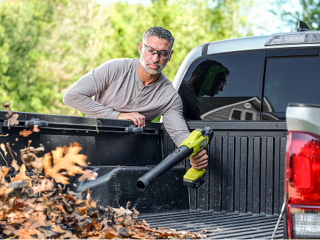 Man blowing out his truck bed with a 18V ONE+ Blower