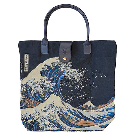 Foldable tote bag featuring Hokusai’s The Great Wave off Kanagawa with blue wave design and navy handles. - Shop Now.