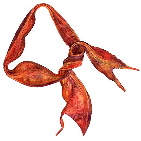 Silk pleated scarf glowing with warm tones of golden yellow and orange. - Shop Now.