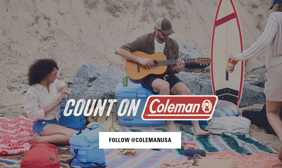 People sitting on a beach with coolers and camping gear, man playing guitar, Coleman logo, follow @colemanusa button