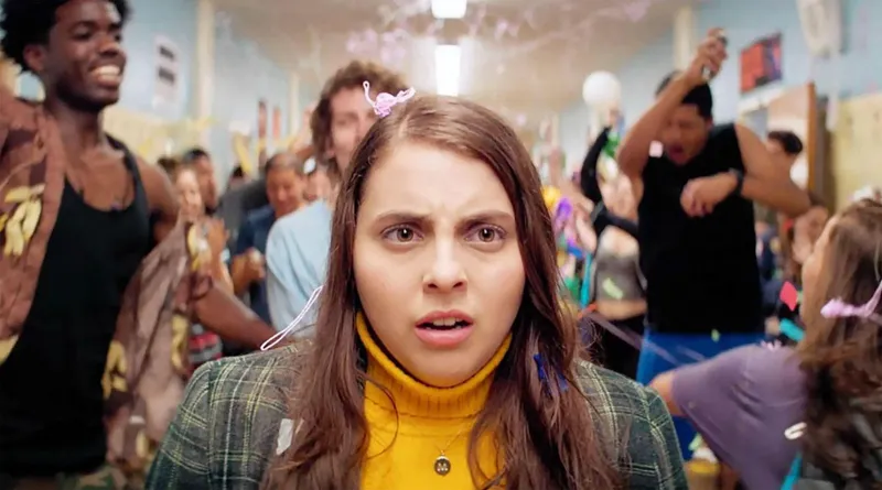 Image may contain: Beanie Feldstein, Head, Person, Face, Photobombing, Brown Hair, Hair, Child, and Sad
