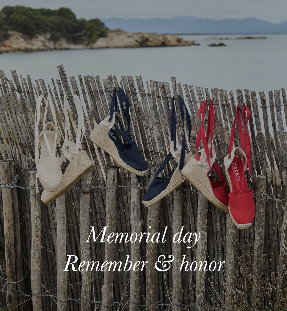 Espadrille wedges in white, navy, and red hanging on a rustic fence by the sea, with the text “Memorial day Remember & honour.”